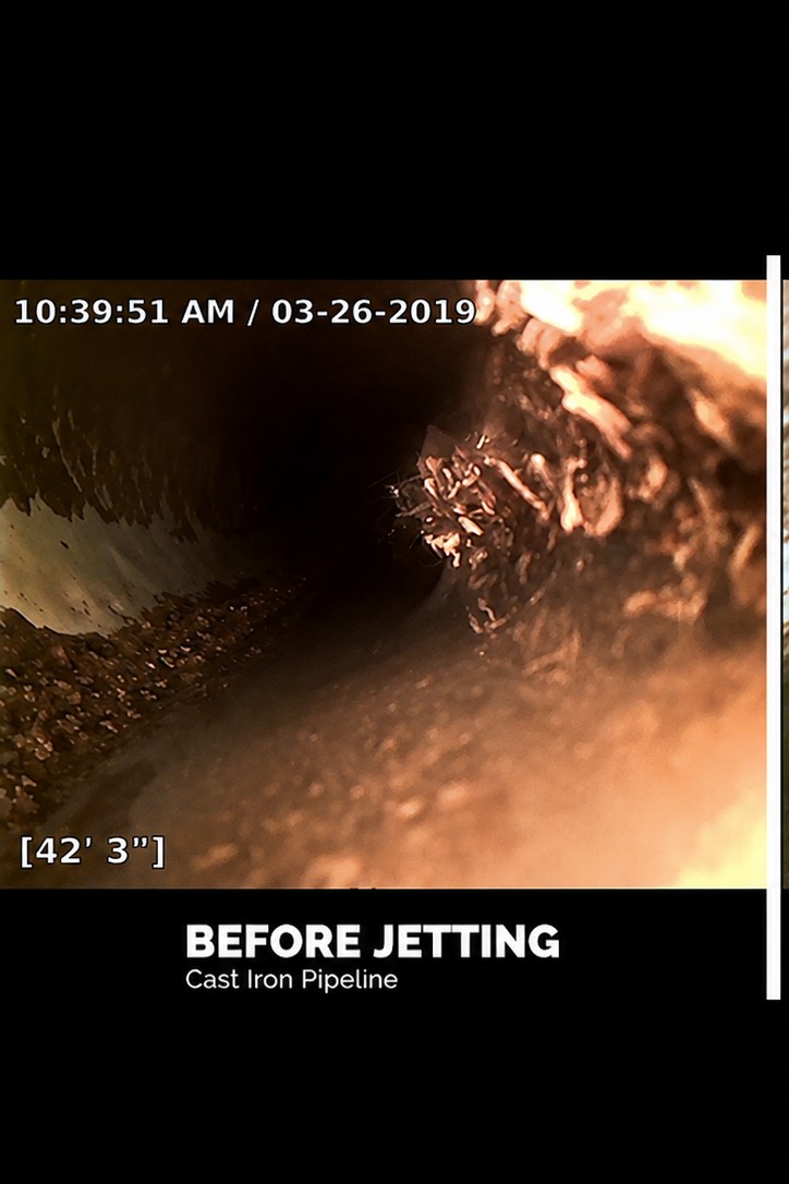 Before hydro jetting: sewer camera view of a Tucson cast iron pipeline clogged with roots and debris at 42 feet 3 inches.
